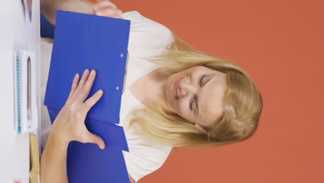 Vertical-video-of-The-woman-examining-the-files-approves-the-files-with-her-head.